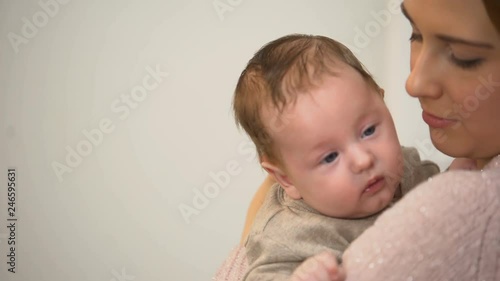Young single mother holding newborn baby tenderly, governmental aid, support