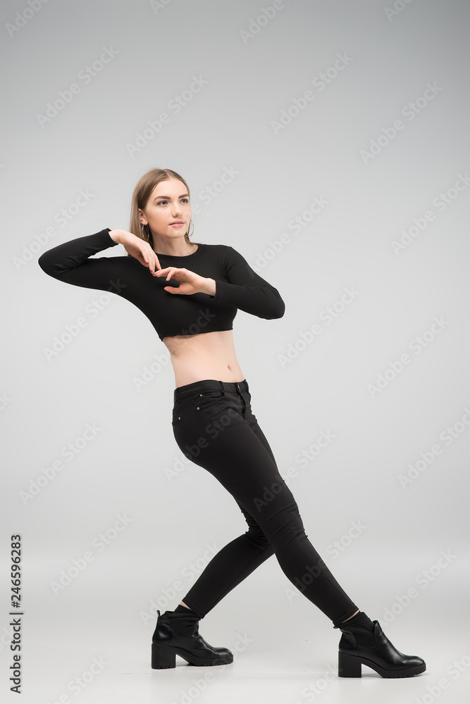 Full length photo of beautiful sexy woman posing in the studio in the black casual clothes Full length photo of beautiful sexy woman posing in the studio in the black casual clothes