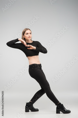 Full length photo of beautiful sexy woman posing in the studio in the black casual clothes