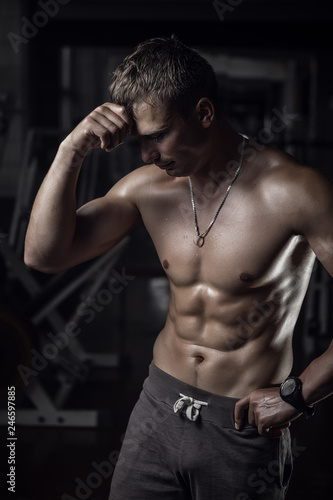 Fototapeta Naklejka Na Ścianę i Meble -  Fitness guy in old rusty gym. Shallow depth of field