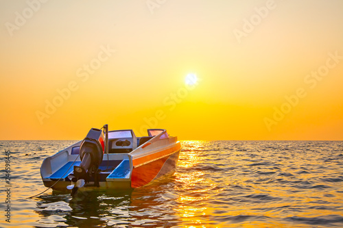 Sunset seascape with a motorboat