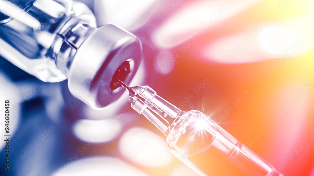 Vaccine vial dose flu shot drug needle syringe,medical concept vaccination hypodermic injection treatment disease care hospital prevention immunization illness disease baby child.blue background Vaccine vial dose flu shot drug needle syringe,medical concept vaccination hypodermic injection treatment disease care hospital prevention immunization illness disease baby child.blue background