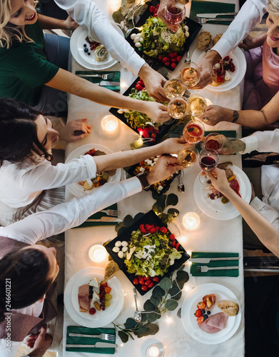 Photography A midsection people sitting at a table on a indoor party, clinking glasses