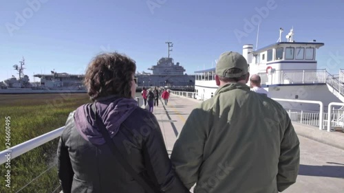 A couple walks toward the USS Yorktown in Charleston SC photo