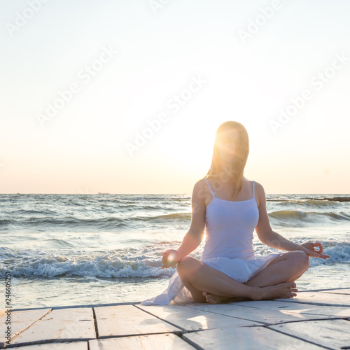 Woman meditating at the sea