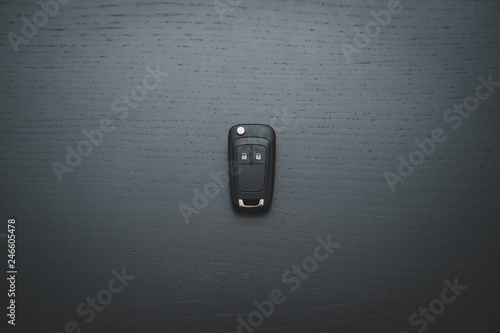 Car key on dark wooden desk photo