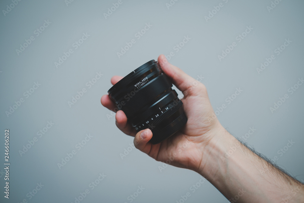 Fototapeta premium Camera lens in hand