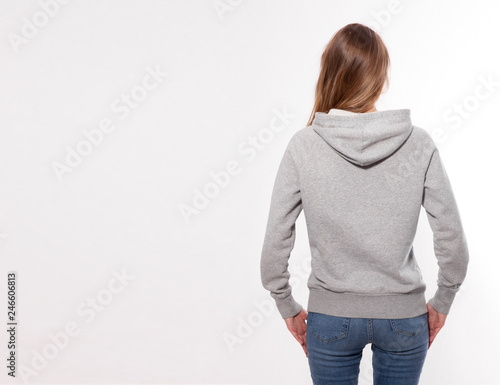 Shirt design and fashion concept - young woman in gray sweatshirt, gray hoodies, blank isolated on white background