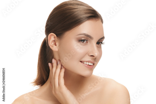 The beautiful happy smiling female face. The perfect and clean skin of face on white. The beauty, care, skin, treatment, health, spa, cosmetic concept