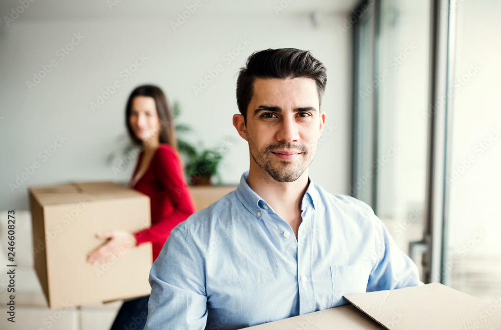Young couple with cardboard boxes moving in a new home. Young couple with cardboard boxes moving in a new home.