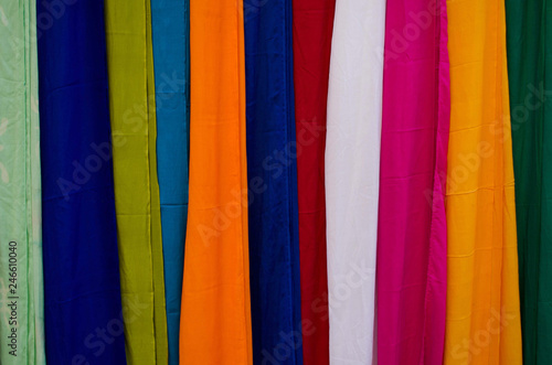 Background of beautiful  different and colorful fabrics of exposed colors