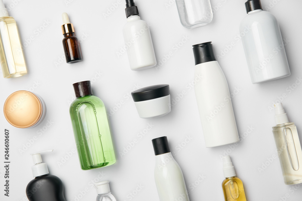 Top view of various cosmetic bottles and containers on white background - obrazy, fototapety, plakaty 