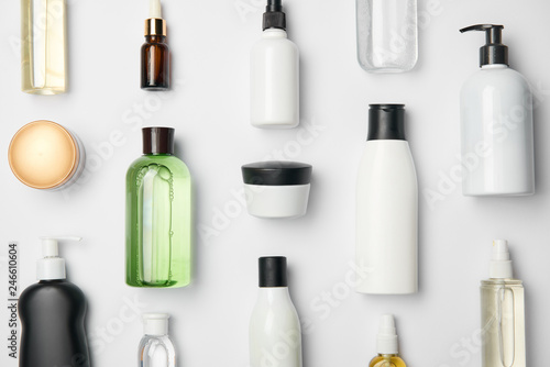 Top view of different cosmetic bottles and container on white background photo