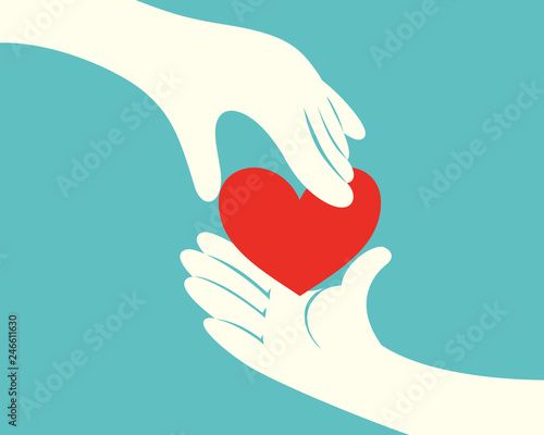 Hand giving a red heart to another hand