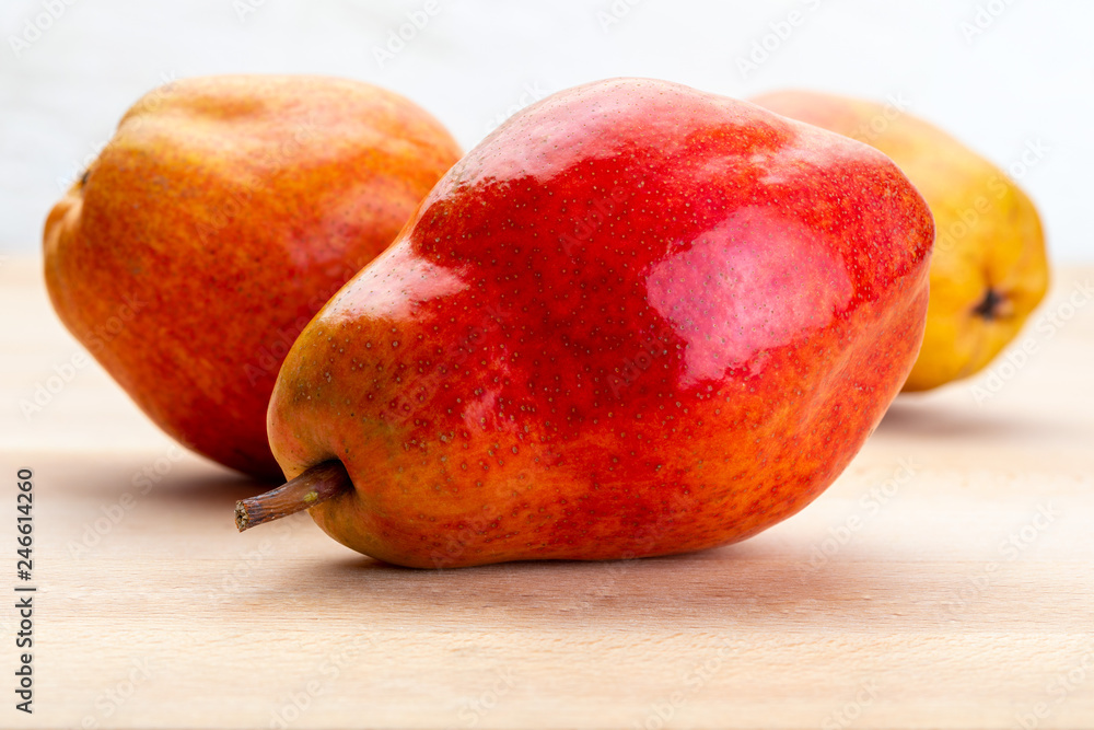 Delicious red pears. On light wood background. Delicious red pears. On light wood background.