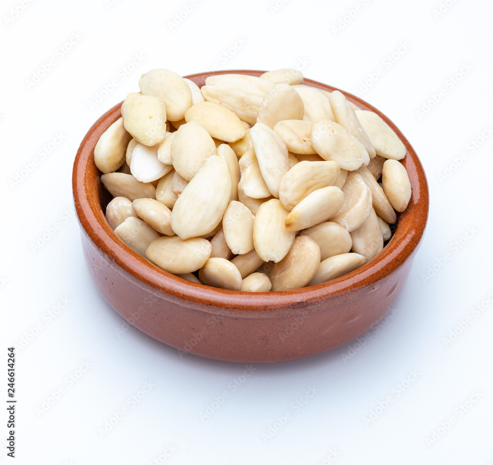 Peeled almonds in clay bowl (Collection of various dried fruits). Isolated on white background. Peeled almonds in clay bowl (Collection of various dried fruits). Isolated on white background.