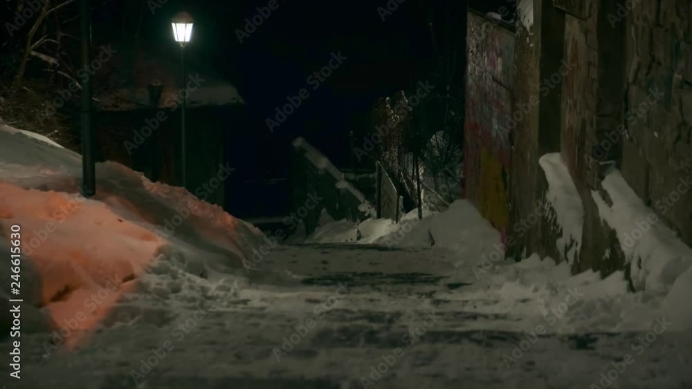 Descending stairs illuminated by a broken street lamp. Natural strobe light. Horror scene Descending stairs illuminated by a broken street lamp. Natural strobe light. Horror scene