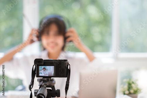 Happy Asian videoblog or student woman beauty blogger / vlogger recording tutorial coach presentation pass video for teaching live homework sharing online channel social media by mirrorless camera