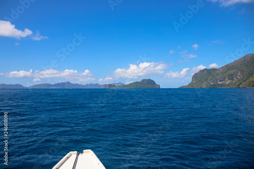 Blue sea and sky landscape. Tropical island hopping by white boat. El Nido Palawan island seascape.
