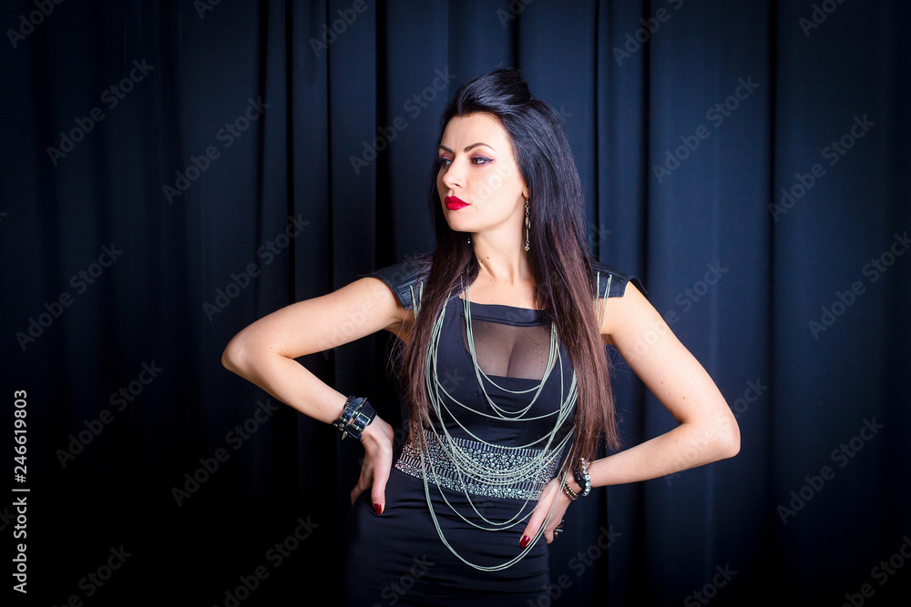 Sexy punk girl. Beautiful girl in rock style with elegant breasts on a dark  background Stock Photo | Adobe Stock