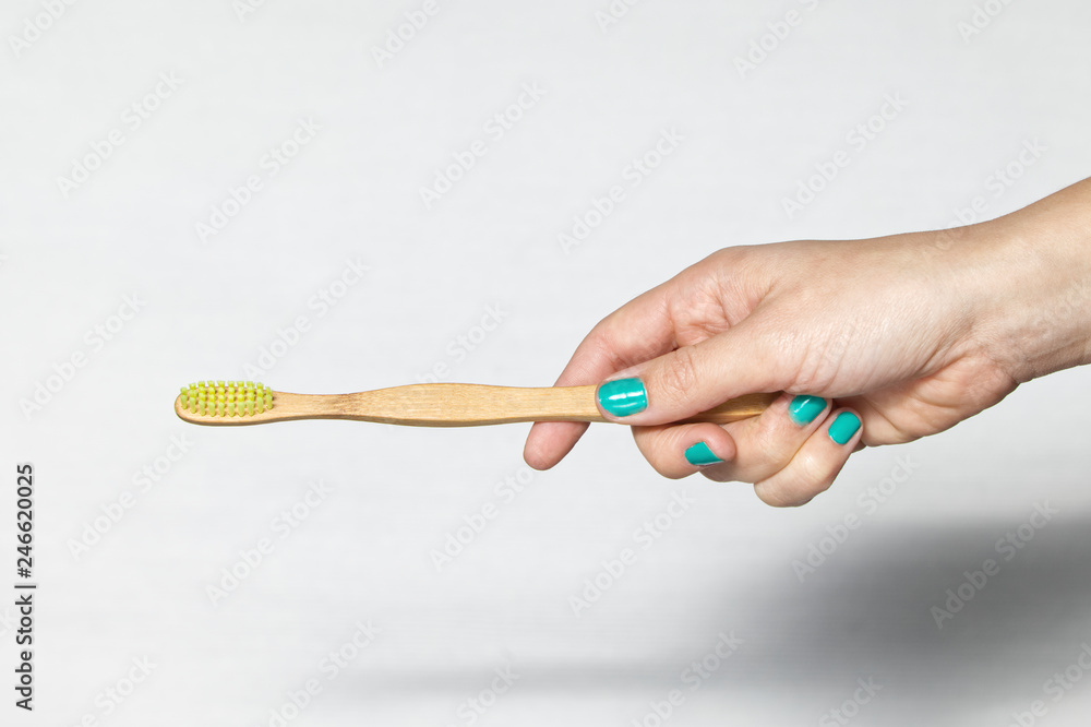 Bamboo Toothbrush in a hand Bamboo Toothbrush in a hand