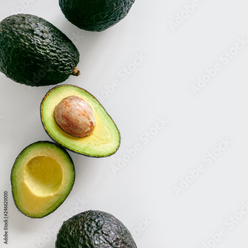 Fresh organic hass avocados on a white background, top view with copy space