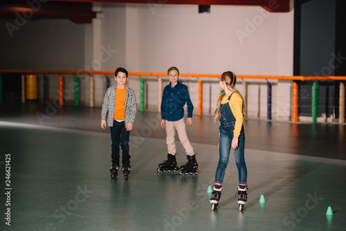 Excited kids fooling around on skater rink