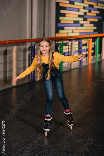 Female roller skater in jeans enjoying childhood