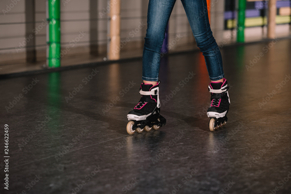 Cropped view of child practicing on roller rink Cropped view of child practicing on roller rink