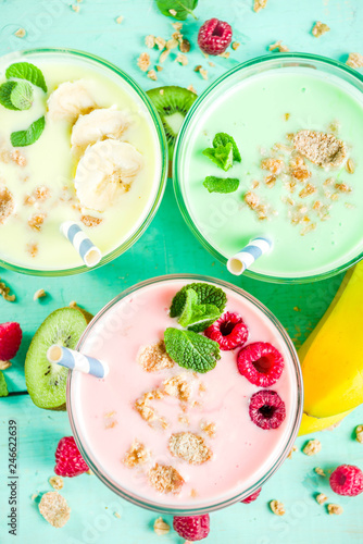 Summer refreshing drinks - protein shakes, milkshakes or smoothies, with fresh berry and fruits, light blue table copy space