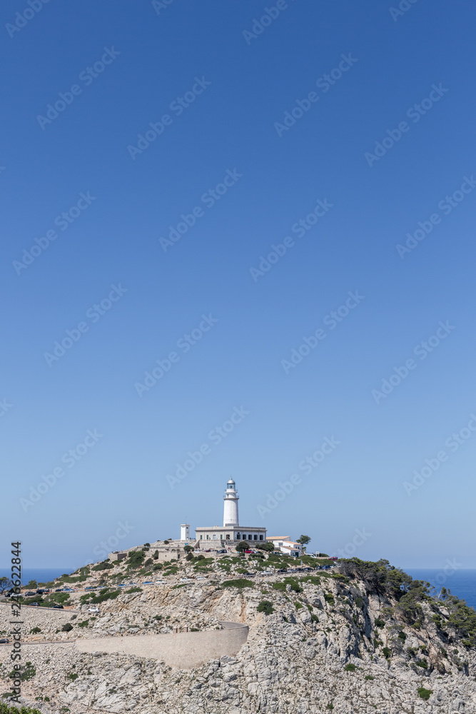 lighthouse Cap Formentor in Mallorca with blue sky in a sunny day, copy space, vertical