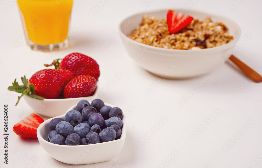 Breakfast with muesli, berries on the white background Breakfast with muesli, berries on the white background