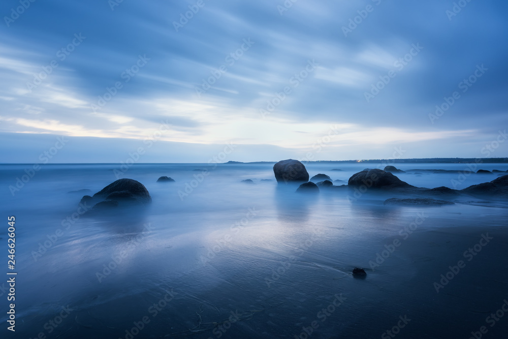 Magic blue morning at the beach / Amazing sea morning with slow shutter and waves flowing out 