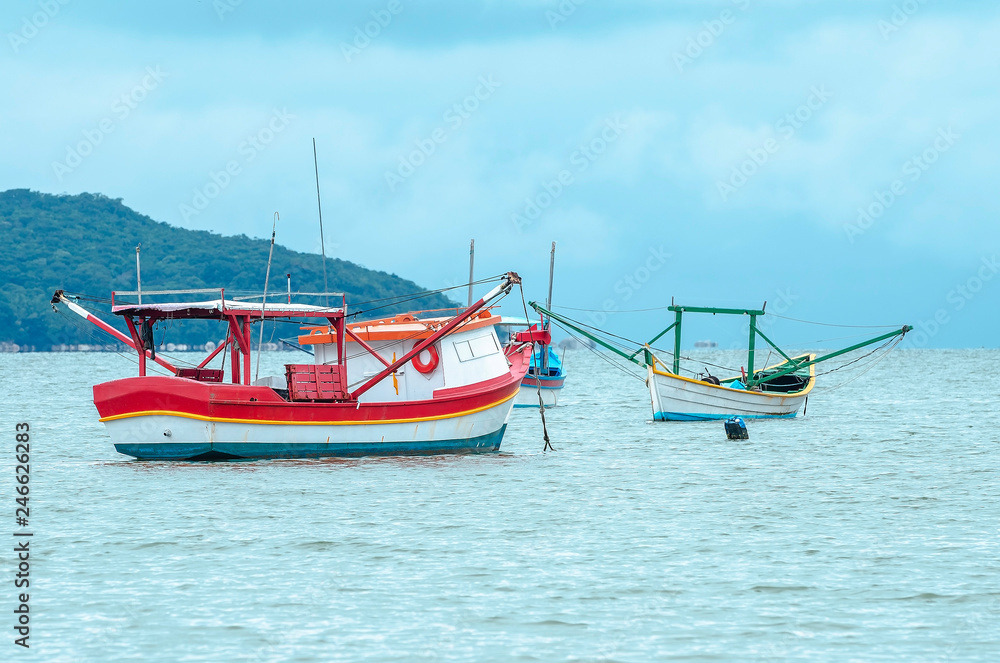 Fishing boats anchored on the sea. Boats at Bombinhas, Praia de Zimbros beach. Fishing boats anchored on the sea. Boats at Bombinhas, Praia de Zimbros beach.