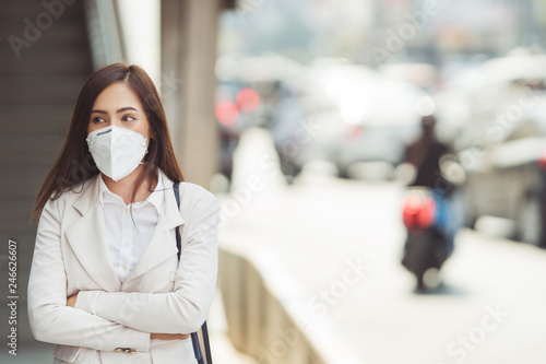 Asian woman are going to work.she wears N95 mask.prevent PM2.5 dust and smog.