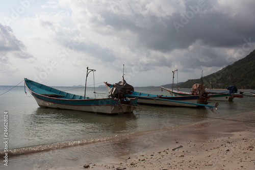 Long-tail boats under cloudy sky in harbor of Koh Phangan island  Thailand