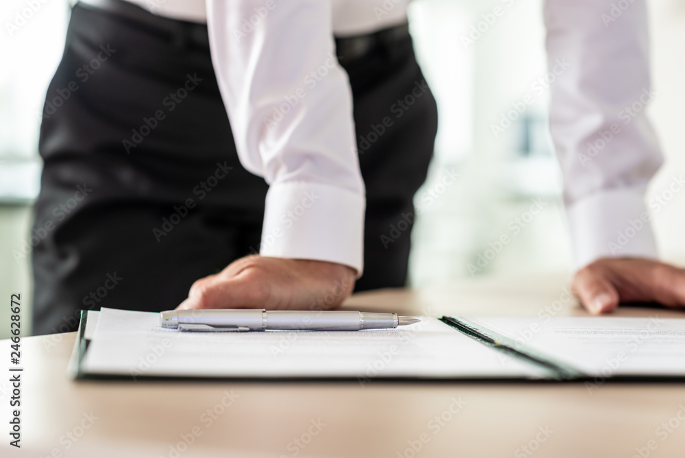 Businessman with paperwork to sign in front of him Businessman with paperwork to sign in front of him