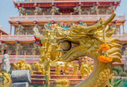 Chinese golden dragon . Beautiful statue of dragon carved around temple pole in Chinese public temple.