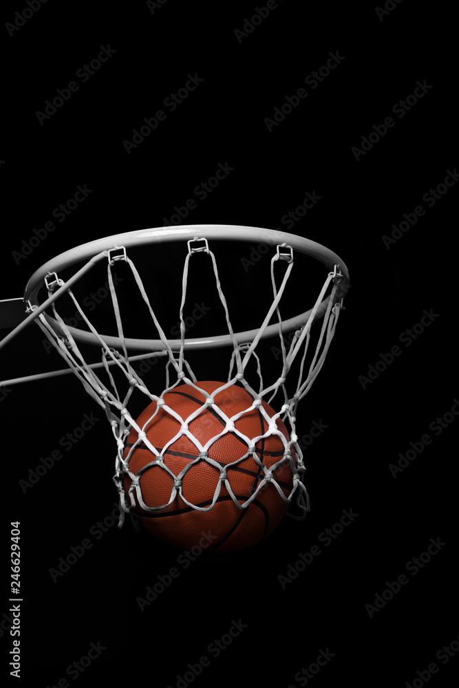 Fototapeta Ball falling through a Basketball Hoop