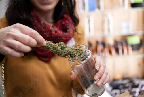 Cannabis Sativa blossom stored in a glass jar.