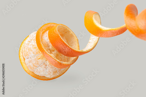 orange peel coiled, peeled orange, orange peeled, on a gray background