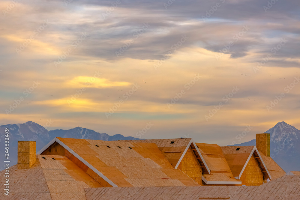 Unfinished roof with mountain and cloudy sky view