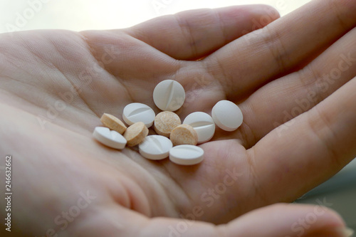 Close up on a hand holding various Medicine Pills