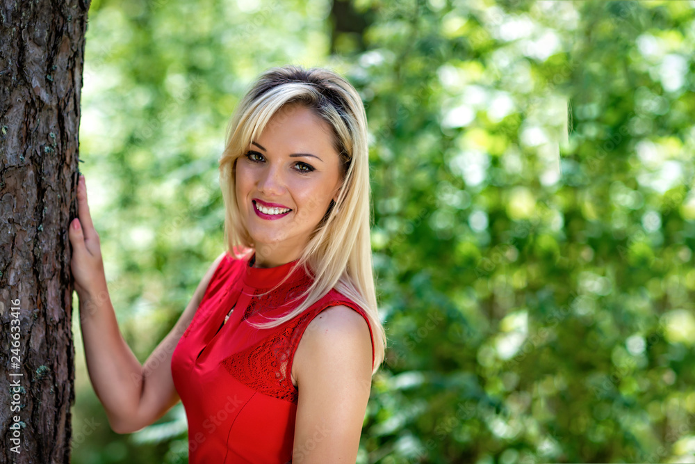 Beautiful, blonde woman portrait on a forest background. Beautiful, blonde woman portrait on a forest background.