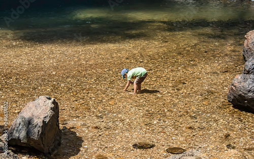 The boys were playing on the rocks and enjoy the Chok Kra-Din WaterFalls at Kanchanaburi in Thailand photo