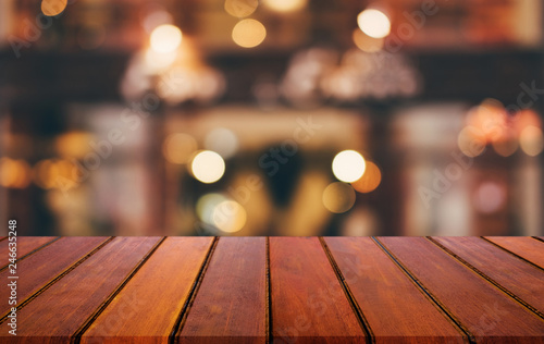 Selective Empty wooden table in front of abstract blurred festive light background with light spots and bokeh for product montage display of product