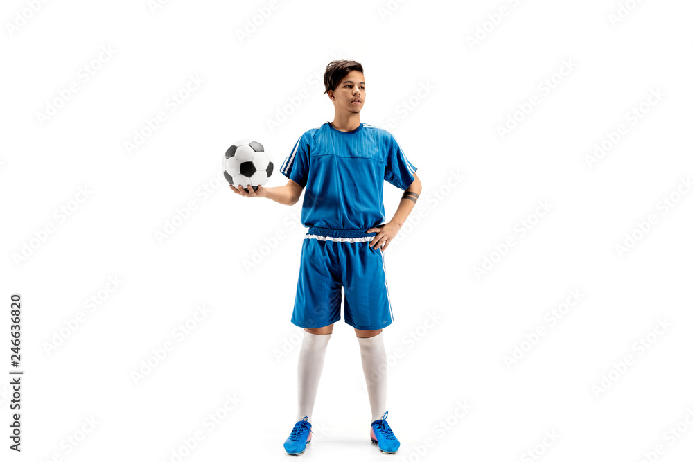 Young fit boy with soccer ball standing isolated on white. The football soccer player on studio background.