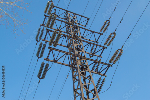 High-voltage power line 110 kV, metal support, wires, insulators, against the blue sky