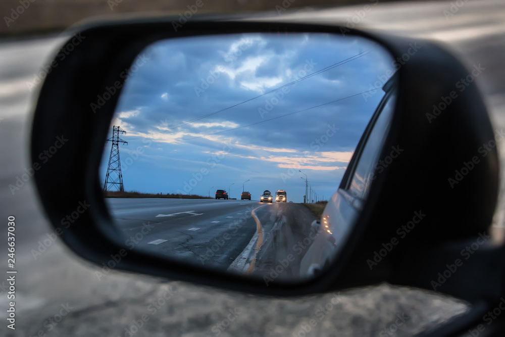 car movement is reflected in the rear-view mirror of the car