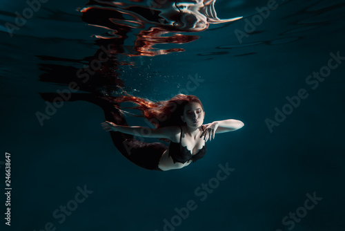 Underwater red haired mermaid freediver girl with tale